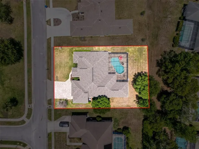 an aerial view of a house with a yard