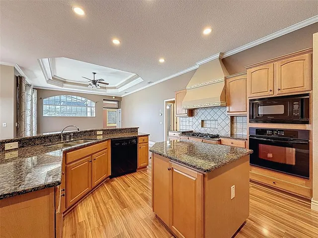 a kitchen with stainless steel appliances granite countertop a stove and a sink