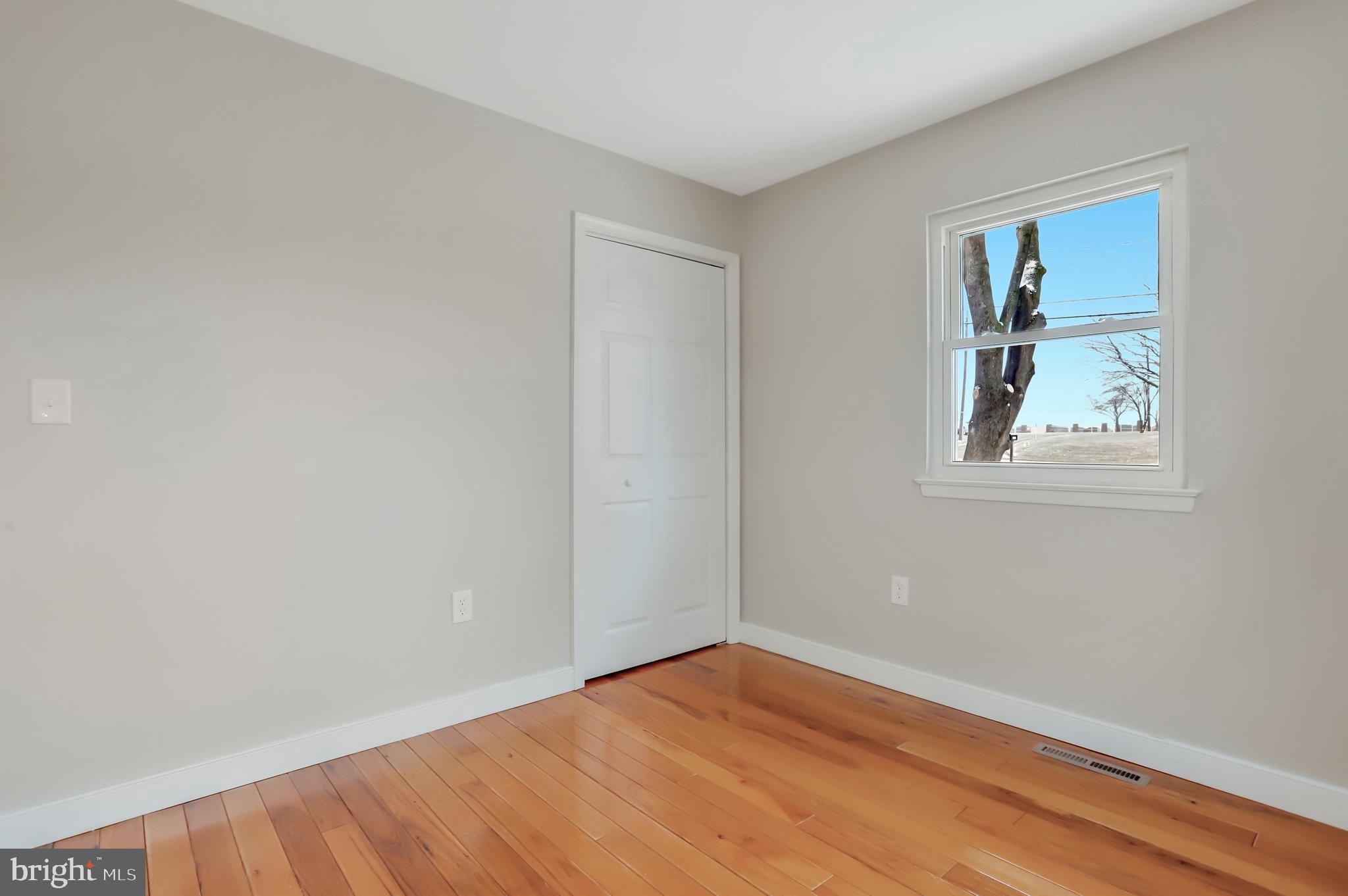 4355 Ridge Road Mount Airy, MD 21771 - Photo 45 of 54 a view of an empty room with wooden floor and a window