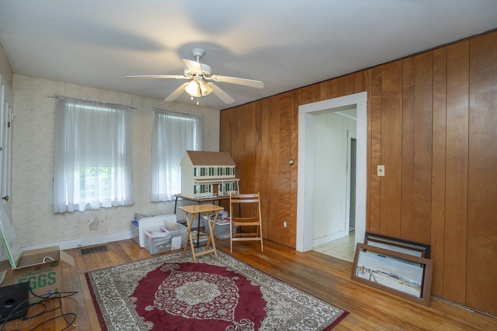 15 Beacon Street Amesbury, MA 01913 - Photo 11 of 41 a living room with furniture and a chandelier