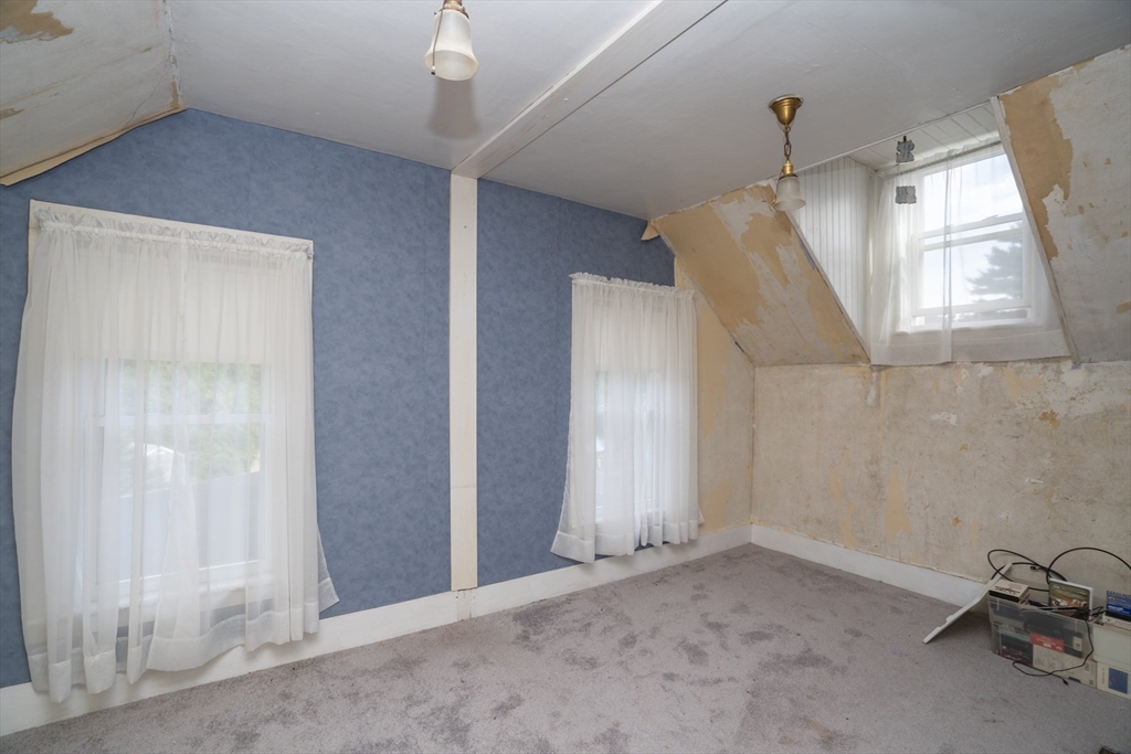 15 Beacon Street Amesbury, MA 01913 - Photo 16 of 41 an empty room with windows & cabinet