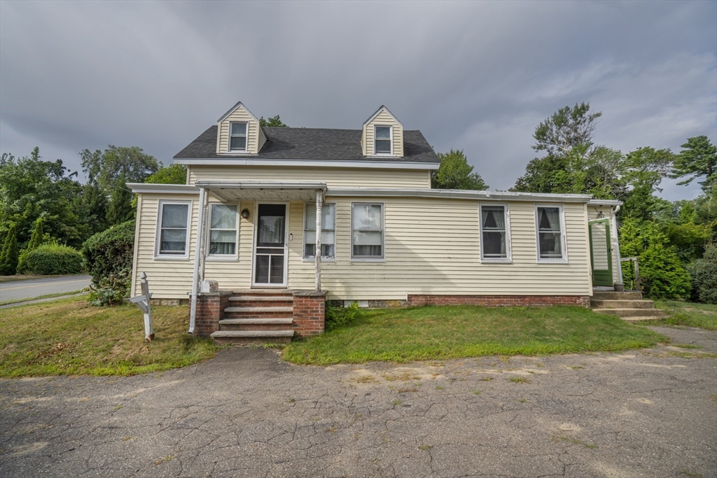 15 Beacon Street Amesbury, MA 01913 - Photo 2 of 41 a front view of a house with a yard and garage