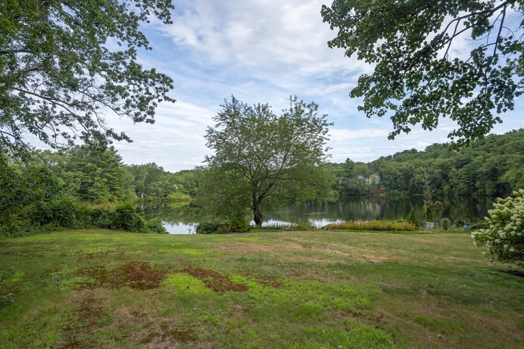 15 Beacon Street Amesbury, MA 01913 - Photo 27 of 41 a backyard of a house with lots of green space and fountain