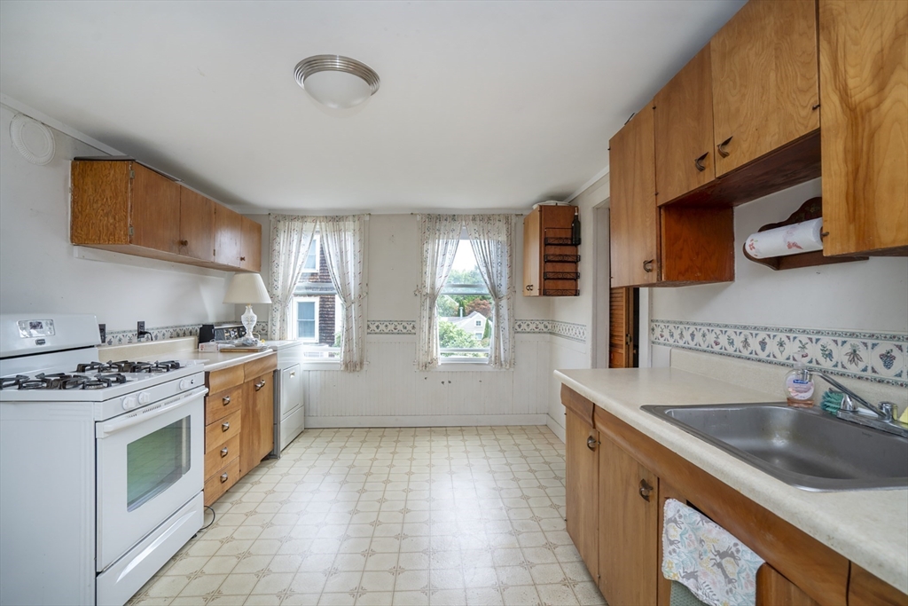 15 Beacon Street Amesbury, MA 01913 - Photo 4 of 41 a kitchen with a sink stove and cabinets