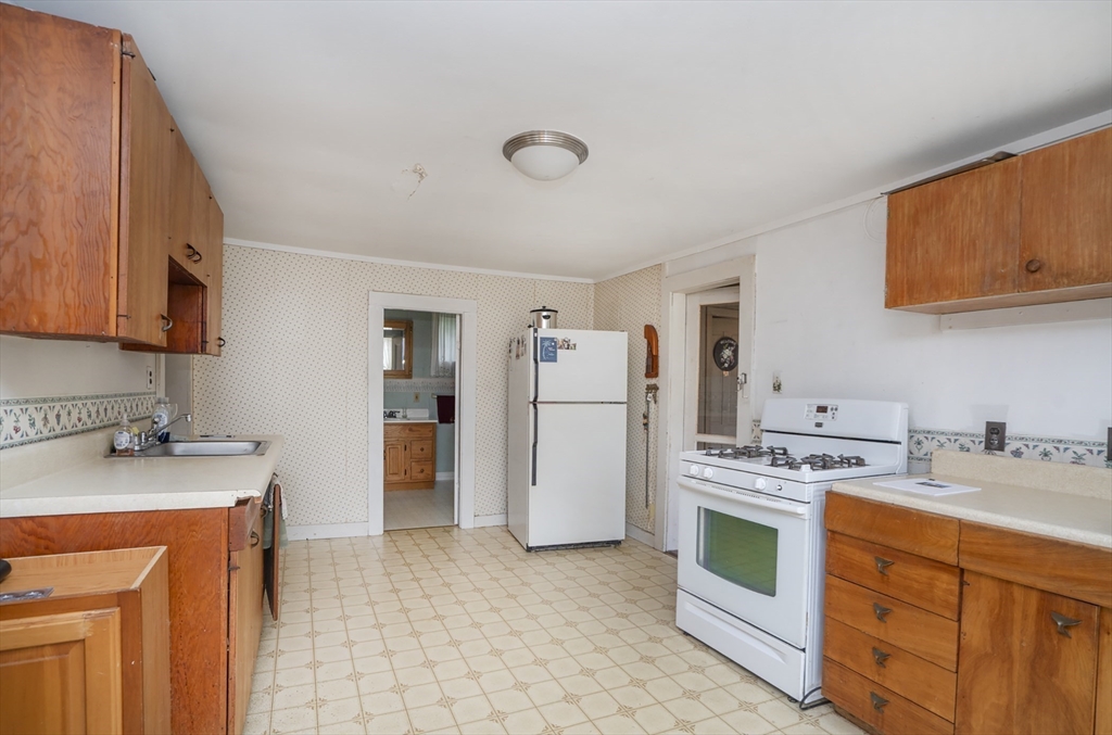 15 Beacon Street Amesbury, MA 01913 - Photo 5 of 41 a kitchen with stainless steel appliances a stove a sink and a refrigerator