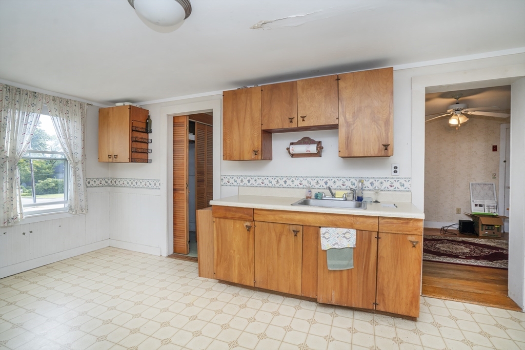 15 Beacon Street Amesbury, MA 01913 - Photo 7 of 41 a large kitchen with granite countertop a sink and cabinets
