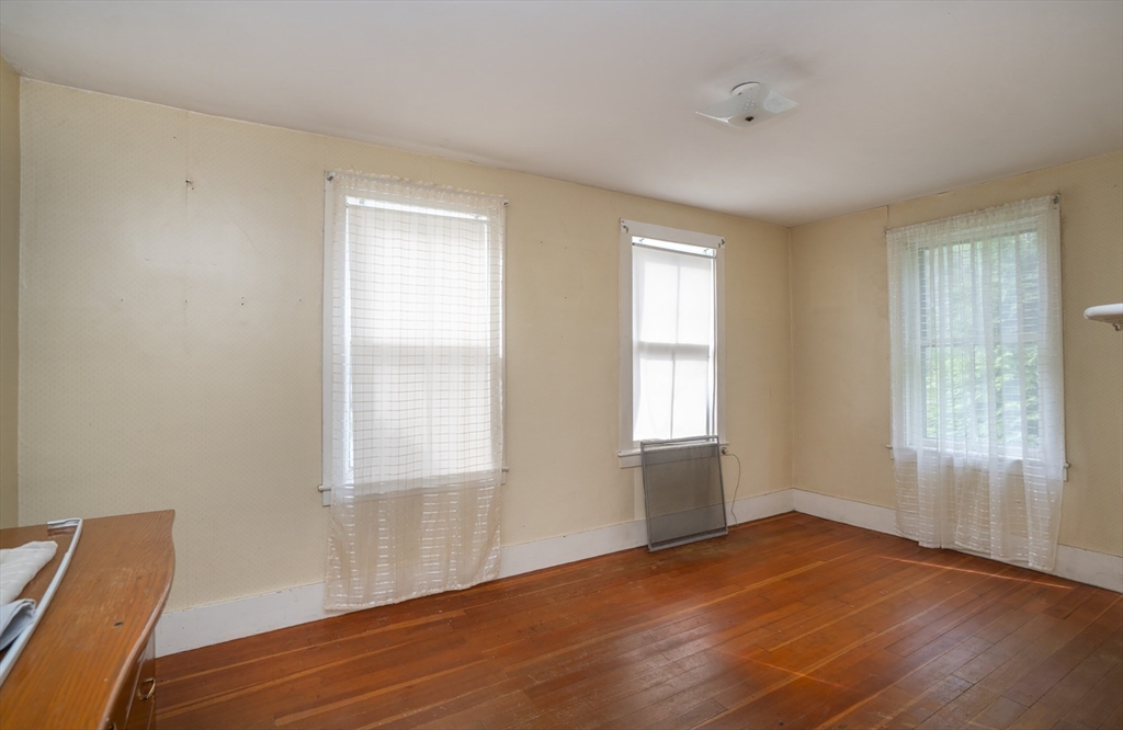 15 Beacon Street Amesbury, MA 01913 - Photo 8 of 41 a view of an empty room with wooden floor and a window