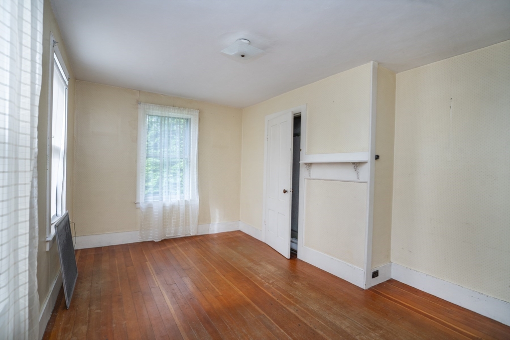 15 Beacon Street Amesbury, MA 01913 - Photo 9 of 41 an empty room with wooden floor and windows