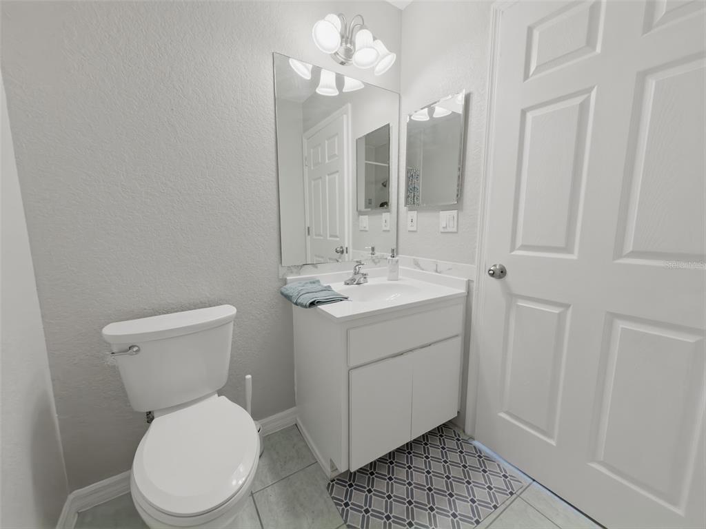 2202 Godfrey Avenue Spring Hill, FL 34609 - Photo 22 of 36 a bathroom with a sink a toilet a mirror and shower