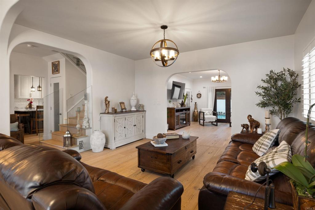 7965 4th Place Downey, CA 90241 - Photo 13 of 41 a living room with furniture a chandelier and a dining table