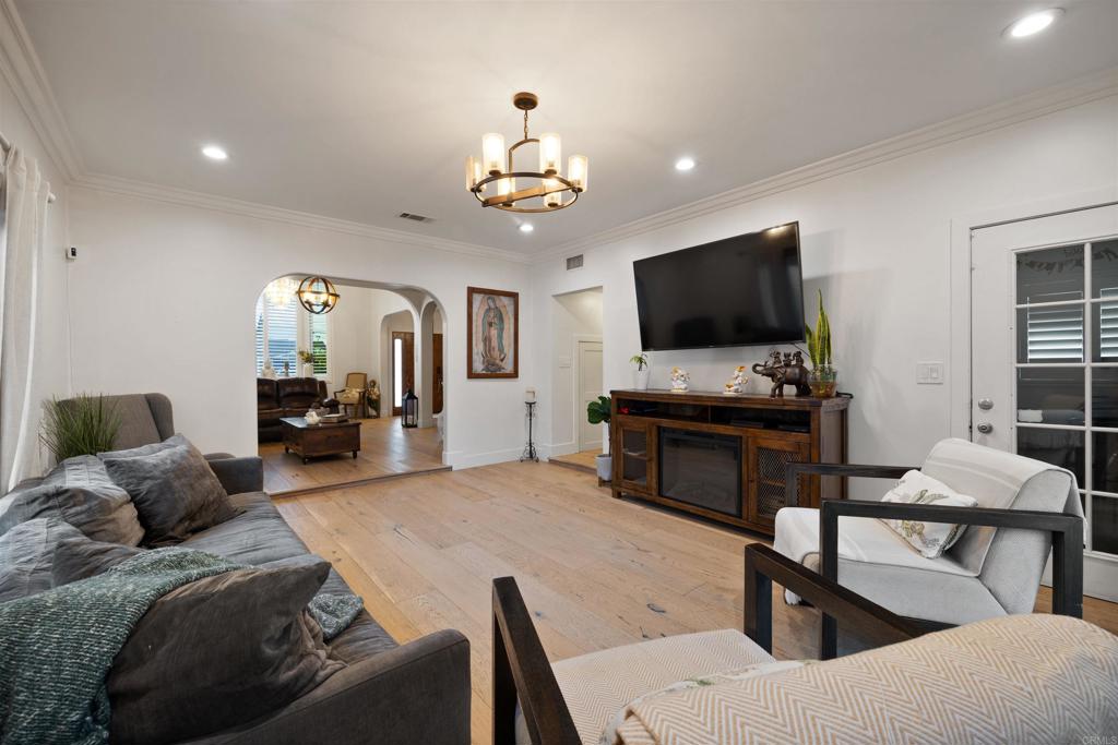 7965 4th Place Downey, CA 90241 - Photo 14 of 41 a living room with furniture a fireplace and a flat screen tv