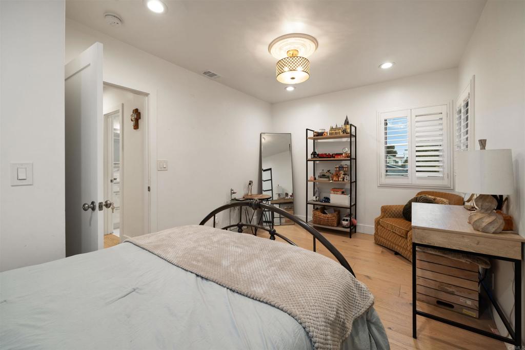 7965 4th Place Downey, CA 90241 - Photo 23 of 41 a bedroom with a bed and a large mirror