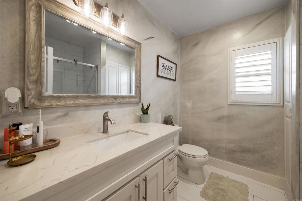 7965 4th Place Downey, CA 90241 - Photo 27 of 41 a bathroom with a sink a toilet and a mirror