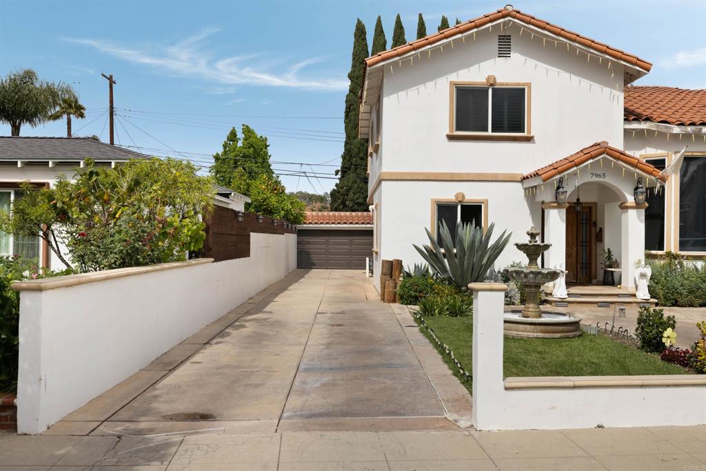 7965 4th Place Downey, CA 90241 - Photo 4 of 41 a front view of a house with a yard and potted plants