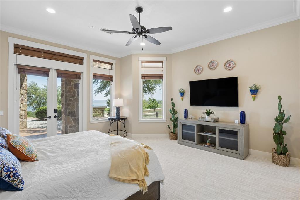 1180 McReynolds Road Sanger, TX 76266 - Photo 24 of 40 Expansive room featuring multiple windows and glass French doors, a ceiling fan with integrated lighting, recessed lighting, and crown molding