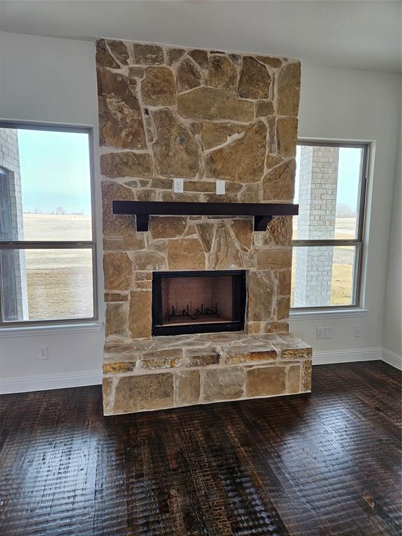 1453 Enloe Road Howe, TX 75459 - Photo 11 of 33 a living room with a fireplace and a floor to ceiling window
