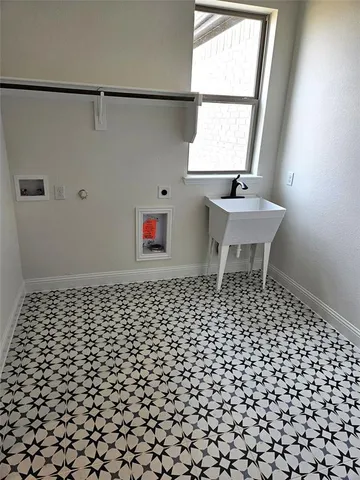 a bathroom with a sink a window and a shower