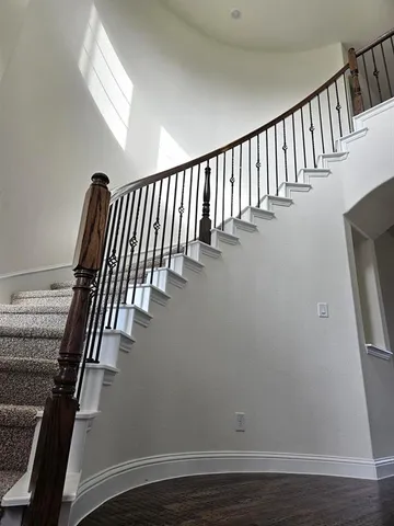 a view of staircase with wooden floor and staircase
