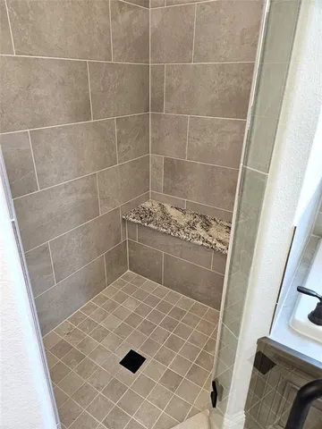 a bathroom with a sink and a shower