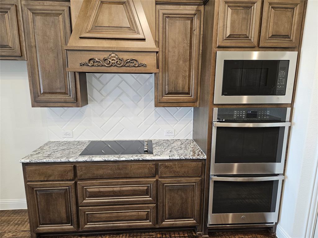 1453 Enloe Road Howe, TX 75459 - Photo 5 of 33 a kitchen with granite countertop cabinets stove and oven