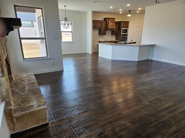 a view of kitchen with cabinets and wooden floor