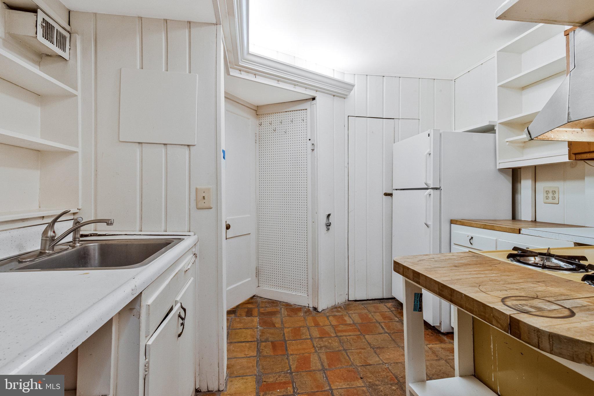 626 A Street Northeast Washington, DC 20002 - Photo 6 of 33 a kitchen with stainless steel appliances granite countertop a sink and a refrigerator