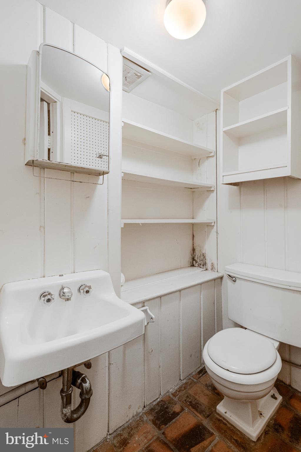 626 A Street Northeast Washington, DC 20002 - Photo 7 of 33 a bathroom with a sink a toilet and vanity