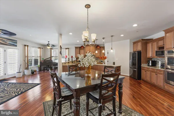 a living room with furniture a flat screen tv and a window