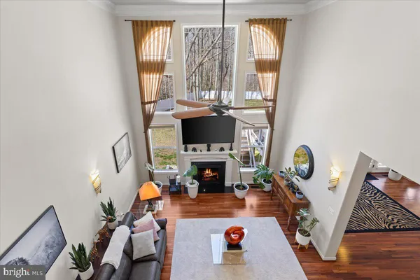 a view of a livingroom with furniture wooden floor and window