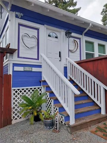 a view of a house with a sitting area and garden