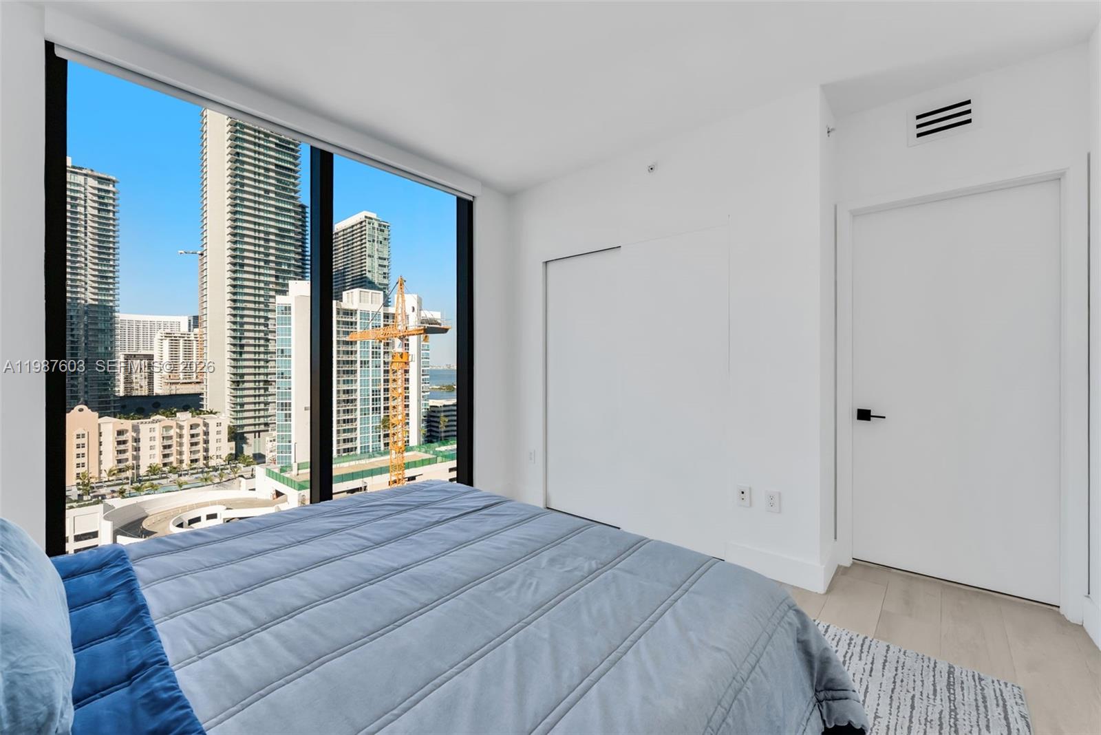 460 Northeast 28th Street, Unit 1601 Miami, FL 33137 - Photo 17 of 41 a bedroom with a bed and a large window