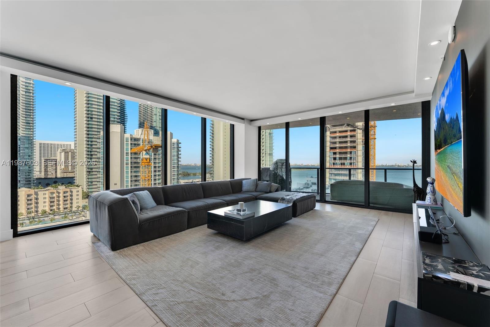 460 Northeast 28th Street, Unit 1601 Miami, FL 33137 - Photo 2 of 41 a living room with furniture window and a flat screen tv