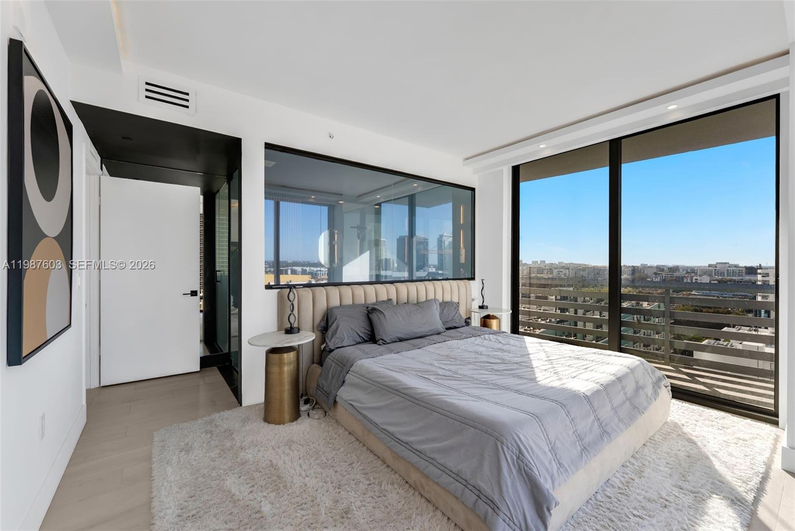 460 Northeast 28th Street, Unit 1601 Miami, FL 33137 - Photo 21 of 41 a bedroom with a large bed and a large window