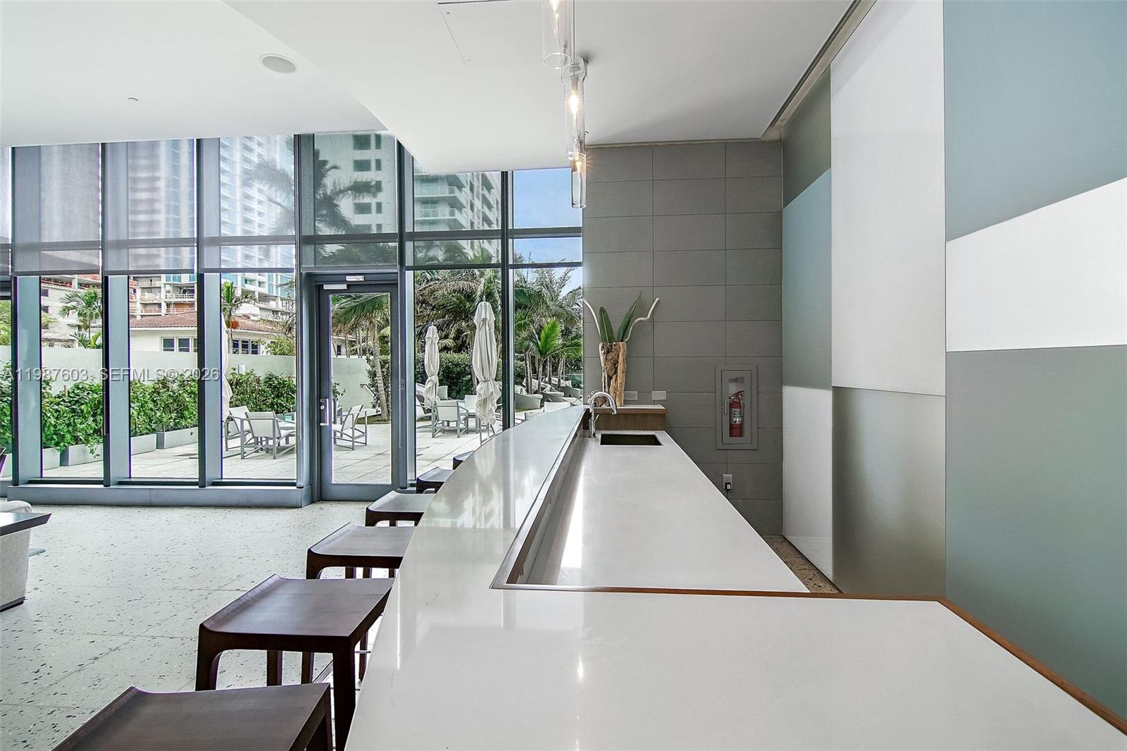 460 Northeast 28th Street, Unit 1601 Miami, FL 33137 - Photo 36 of 41 a living room with furniture and a floor to ceiling window