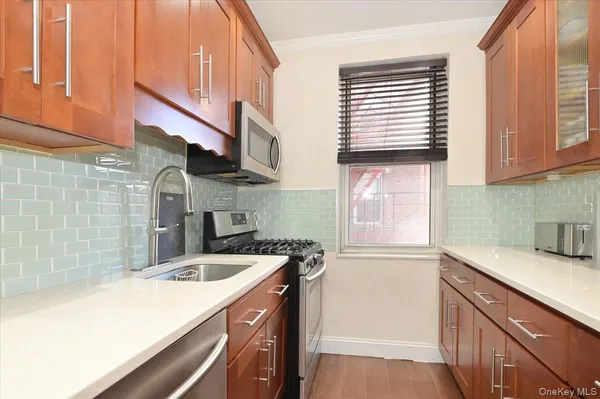 a kitchen with a sink cabinets and window