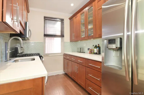 a kitchen with a refrigerator a sink and cabinets