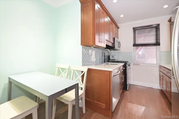 a kitchen with a sink cabinets and wooden floor