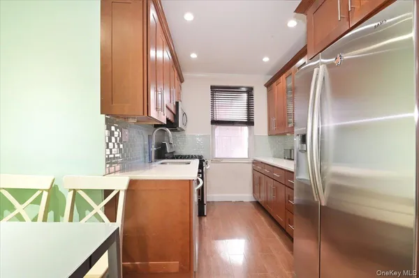 a kitchen with kitchen island a sink a stove and a refrigerator