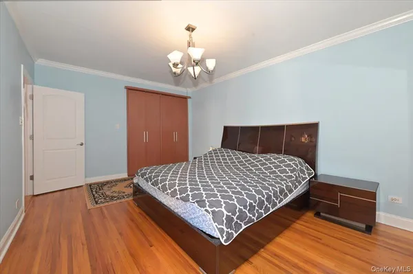 a bedroom with wooden bed and wooden floor