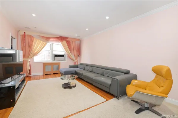 a living room with furniture a flat screen tv and a large window