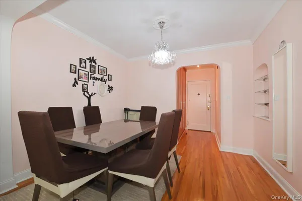 a view of a dining room with furniture wooden floor and a chandelier