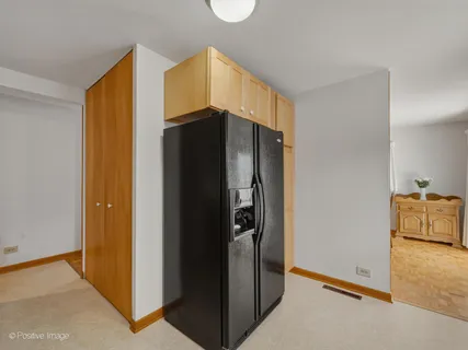a metallic refrigerator freezer sitting in a kitchen