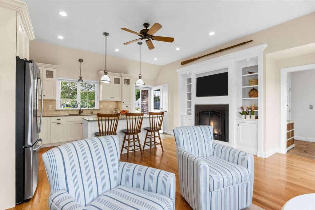 110 Commerce Road Barnstable, MA 02630 - Photo 13 of 41 a living room with furniture a fireplace and a flat screen tv
