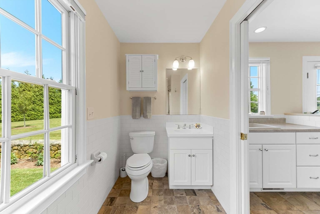 110 Commerce Road Barnstable, MA 02630 - Photo 18 of 41 a spacious bathroom with a toilet sink and a mirror