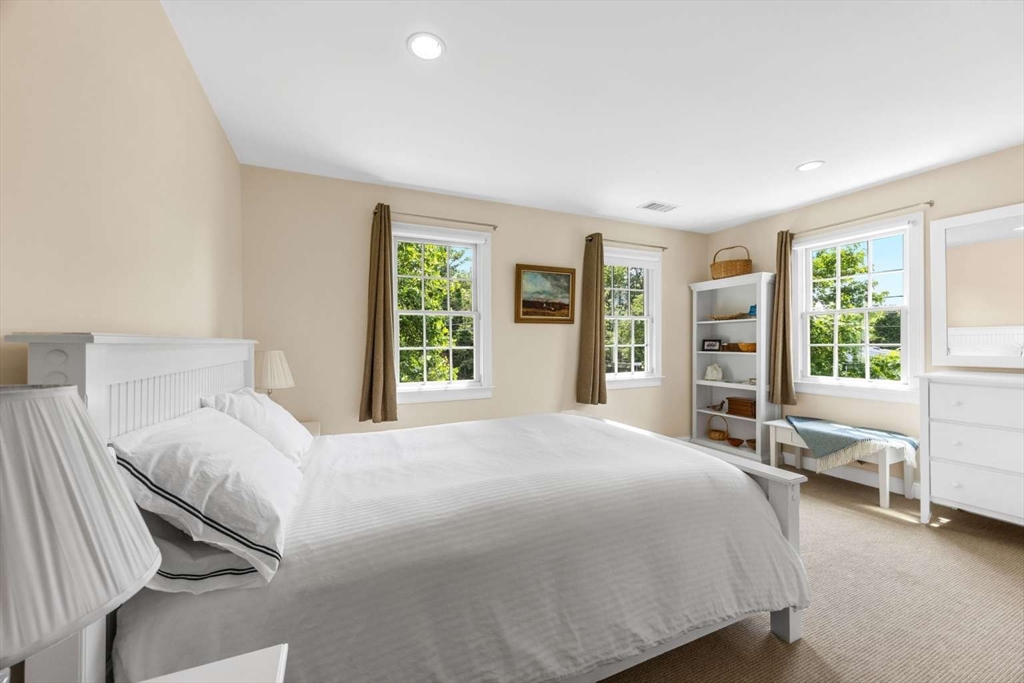 110 Commerce Road Barnstable, MA 02630 - Photo 35 of 41 a bedroom with a large bed and large windows