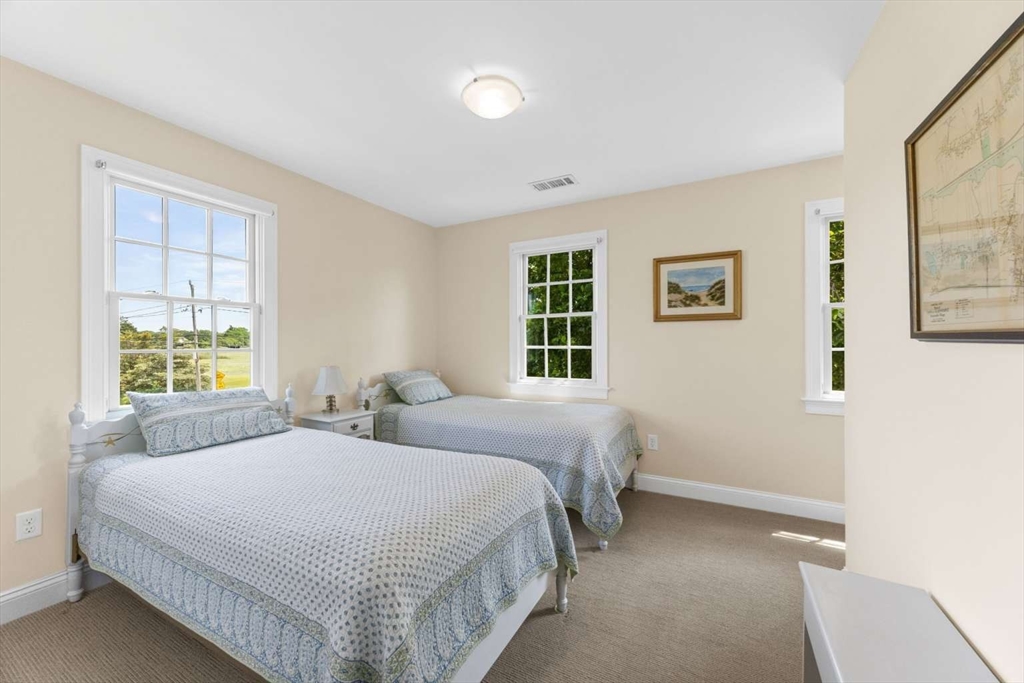 110 Commerce Road Barnstable, MA 02630 - Photo 37 of 41 a bedroom with two beds and a window