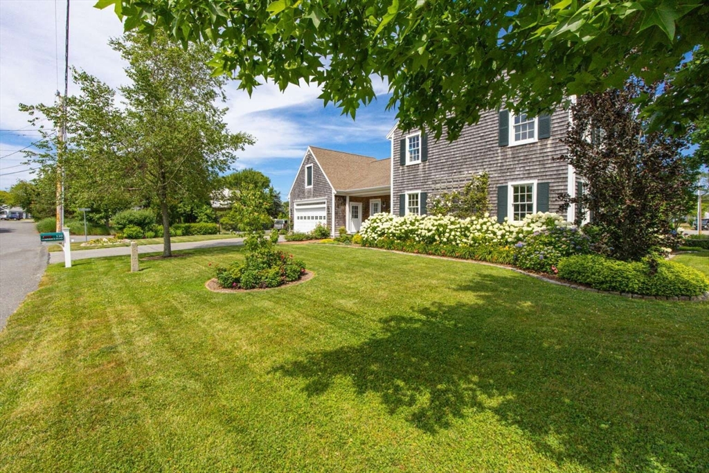 110 Commerce Road Barnstable, MA 02630 - Photo 4 of 41 a front view of a house with a yard
