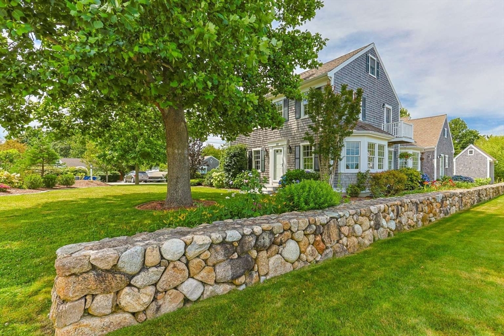 110 Commerce Road Barnstable, MA 02630 - Photo 6 of 41 a front view of a house with garden