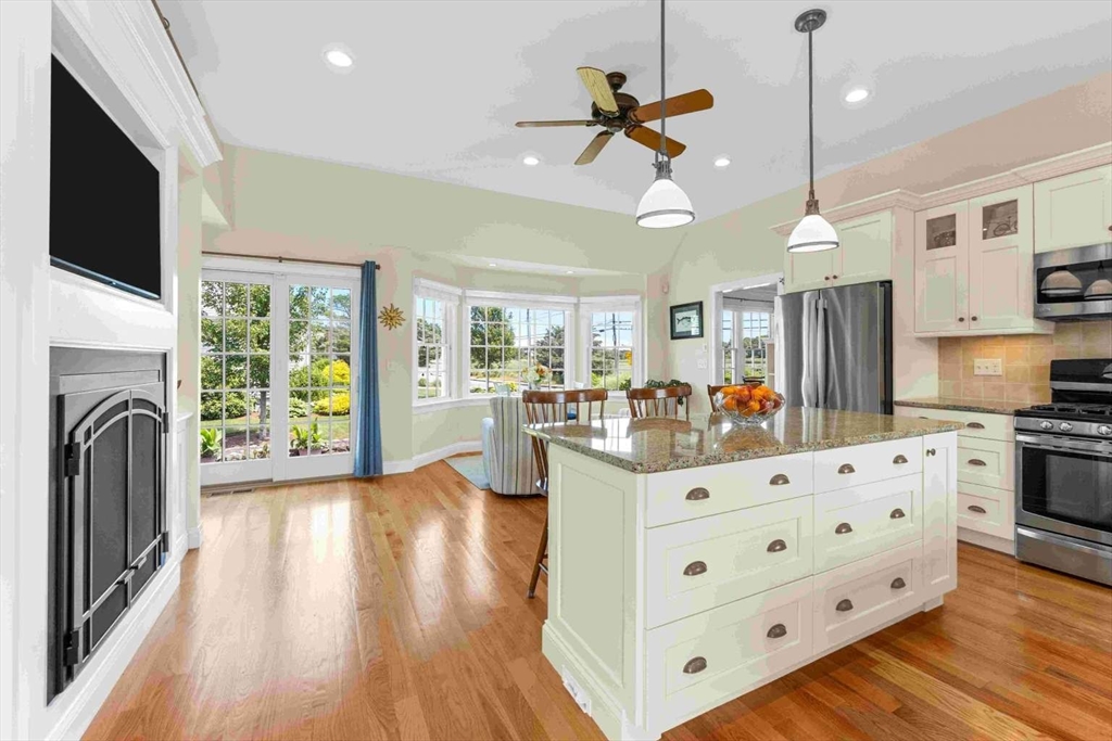 110 Commerce Road Barnstable, MA 02630 - Photo 8 of 41 a view of a kitchen with furniture and a fireplace