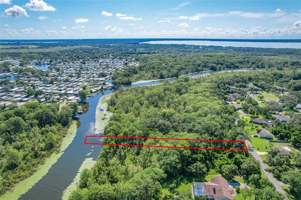Creek Road Leesburg, FL 34788 - Photo 2 of 19 a view of a garden with a building in the background
